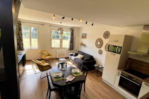 a living room with a couch and a table in a room at La Cabarette in Arry