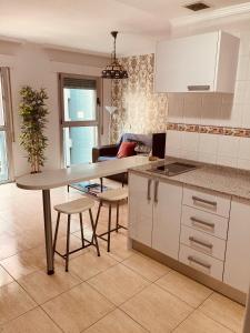 a kitchen with a table and chairs in a room at Tiffany's Apartment in Las Palmas de Gran Canaria