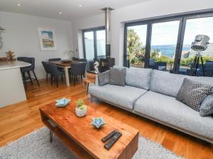 a living room with a couch and a table at Seafield in Carbis Bay