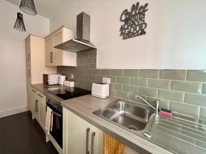 a kitchen with a sink and a counter top at Market Street Casa by KP in Nottingham