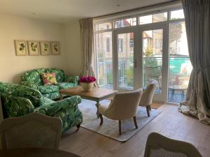 a living room with a couch and a table at Walcot Yard, Bath in Bath