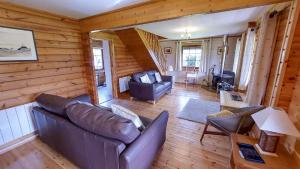 a living room with a couch and a table at Eirianfa in Menai Bridge