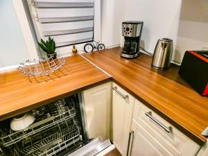 a kitchen with a wooden counter top with a dishwasher at *****Luxus-Flat im Herzen von Hilden in Hilden