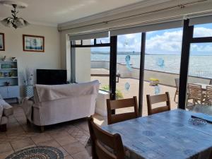 a living room with a view of the ocean at High Tide in Duncannon