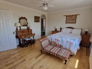 a bedroom with a bed and a mirror and a piano at High Tide in Duncannon