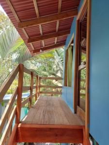 a wooden walkway leading to a house with a roof at Casa LalitoHouse cabaña rustica frente al mar. in Pavones
