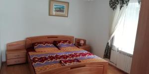 a bedroom with a bed with red shoes on it at Apartmani kod Rade in Pakoštane