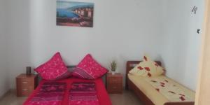 a living room with a couch and pillows at Apartmani kod Rade in Pakoštane