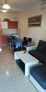 a living room with a couch and a table at Apartmani kod Rade in Pakoštane