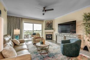 a living room with a couch and a tv at Marina Inn 4-303B in Myrtle Beach