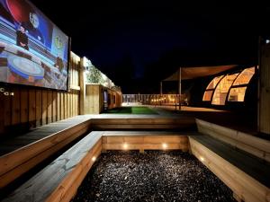 a night view of a walkway with lights on it at Sunrise Dome Tent in Tenby