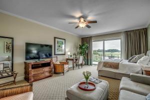 a living room with a bed and a flat screen tv at Marina Inn 4-303 in Myrtle Beach