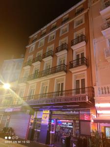 a building with a sign on the front of it at Hotel Du Rocher in Lourdes