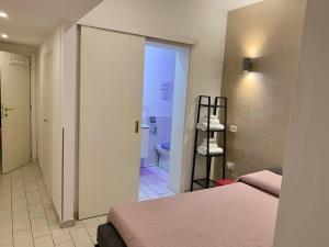 a room with two beds and a bathroom with a toilet at Chroma Apt Farinone 28 in Rome