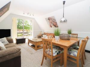 a living room with a wooden table and chairs at 17 Valley Lodges in Callington