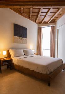 a bedroom with a large bed and a large window at Repetita Juvant in Rome