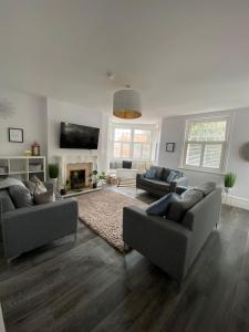 a living room with two couches and a fireplace at The Beverley Suite in Sheringham