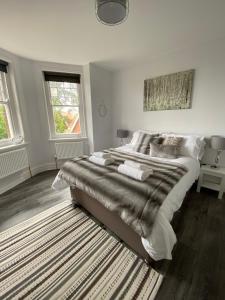 a bedroom with a large bed and a rug at The Beverley Suite in Sheringham