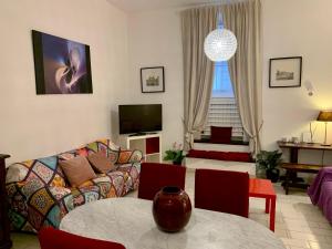a living room with a couch and a table at Chroma Apt Farinone 28 in Rome