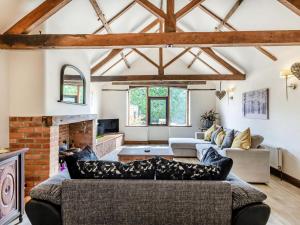 a living room with a couch and a fireplace at High House Barn - Uk36929 in Foulsham