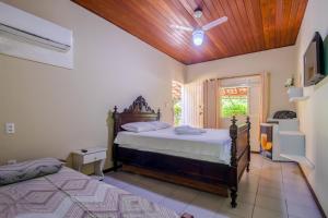 a bedroom with two beds and a ceiling fan at Pousada Marezia Top 5 na Linha Verde in Porto de Sauipe