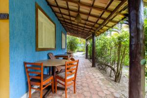 a table and chairs sitting outside of a house at Pousada Marezia Top 5 na Linha Verde in Porto de Sauipe