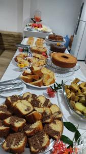 a table topped with plates of bread and desserts at Pousada Ponta da Baleia in Barra Grande