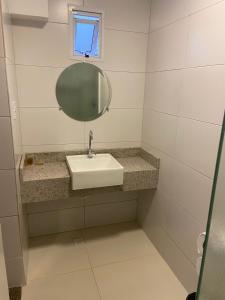 a bathroom with a sink and a mirror at Hotel Imperador in Santos