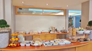 a kitchen with a counter with food on it at Hotel Brenner - Stop & Go in Vipiteno