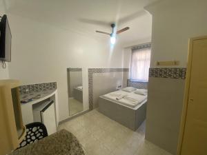 Postel nebo postele na pokoji v ubytování Hotel Bom Gosto
