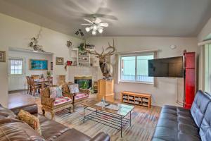 a living room with a couch and a tv at Quaint Ranch Home with Yard in Midtown Anchorage! in Anchorage