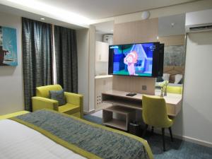 a hotel room with a bed and a television at Touq Balad in Jeddah