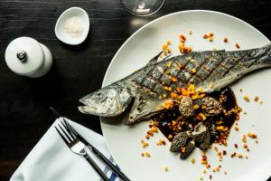 une assiette de nourriture avec un poisson sur elle dans l'établissement Kimpton Palladian Hotel by IHG, à Seattle 95 autres photos