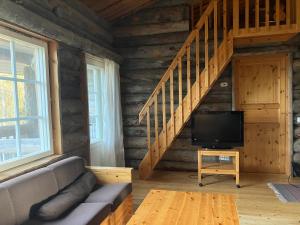 a living room with a couch and a flat screen tv at RepoRuka in Ruka