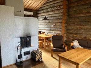 a living room with a fireplace and a table at RepoRuka in Ruka