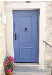 a blue door with a potted plant in front of it at Magnolia Luxury Rooms in Split