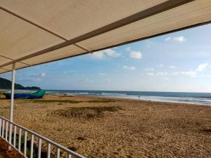 a view of the beach from the balcony of a house at Agonda Paradise in Agonda