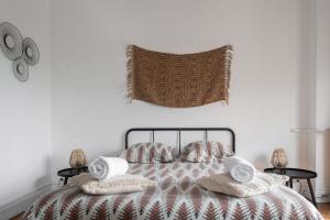 a bedroom with a bed with pillows and a blanket at Residence Le Paris - 57b Rue de Paris - Vichy in Vichy