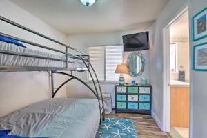 a bedroom with a bunk bed and a bathroom at Pismo Beach Condo Less Than Walk to Beach and Wineries! in Pismo Beach