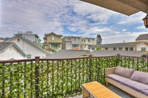 a privacy fence with a couch on a patio at Pismo Beach Condo Less Than Walk to Beach and Wineries! in Pismo Beach