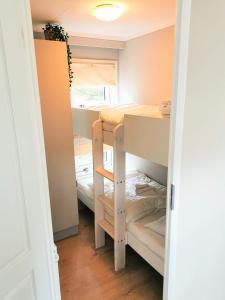 a small room with bunk beds in it at Boslodge 84 in Vorden