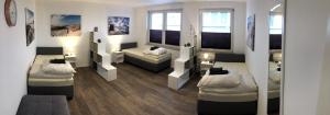 a room with two beds and a couch in it at VerwöhnWohnungDeluxe in Wuppertal