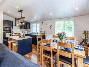 a kitchen and dining room with a table and chairs at Lavender Lodge in Willington