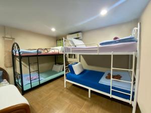 a room with three bunk beds in it at 4J Lodge in Bangkok