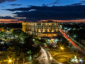 a city at night with a building and street lights at Fiesta Americana Merida in Mérida
