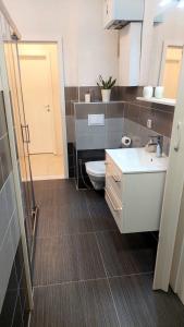 a small bathroom with a toilet and a sink at La Vita E Bella in Sarajevo