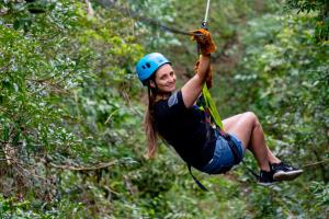 a woman on a zip line in the jungle at Rinconcito Lodge in Liberia