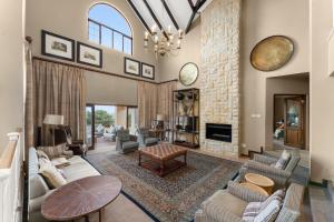 a living room filled with furniture and a fireplace at Drakensberg Luxury Accommodation - Misty Ridge in Himeville