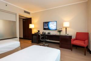 a hotel room with a bed and a desk and a chair at Eurobuilding Hotel Boutique Buenos Aires in Buenos Aires