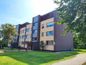 an apartment building with a park in front of it at Modern city center apartment in Sigulda